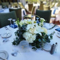 Log Cabin Florist - Beautiful centerpiece with white hydrangeas, lilies, thistle, roses eucalyptus and more...