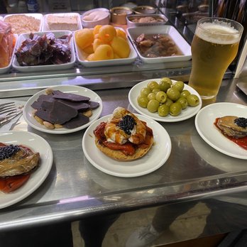 Quimet & Quimet - From right to left: Smoked oyster, tuna belly, prawn montadito, assorted olives and another smoked oyster. - Tapas Bars Near Me - Barcelona, B