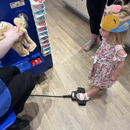 Filling up her bear with stuffing