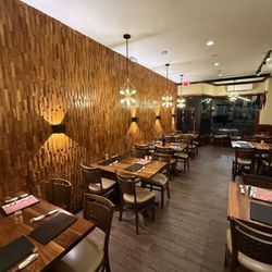 QUILLA by Sabor Peruano - Elegant dining room at QUILLA by Sabor Peruano -- warm wood textures, soft lighting, and authentic Peruvian ambiance in Rahway.