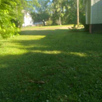 Conley Lawn Care - a lawn with a lawn mower in the foreground - Lawn Services Near Me Conley Lawn Care - a lawn with a lawn mower in the foreground - Lawn Services Near Me