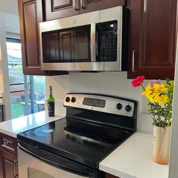 Surface Shield Roofing Company - New cabinets with over the range microwave hood, quartz countertops and backsplash - Roofing Near Me - Waipahu, Hawaii