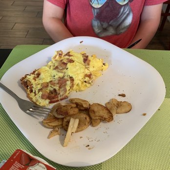 Lemon Cafe - a person sitting at a table with a plate of food - Breakfast & Brunch Near Me - Deerfield Beach, Florida Lemon Cafe - a person sitting at a table with a plate of food - Breakfast & Brunch Near Me - Deerfield Beach, Florida