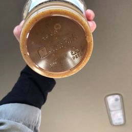 a person holding a jar of coffee a person holding a jar of coffee