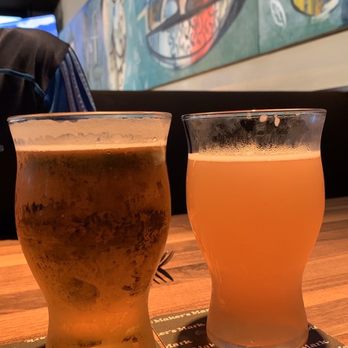 Yard House - House Golden Pilsner (L) and Paradise Ciders Guava Lava (R) - New American Near Me - Honolulu, Hawaii Yard House - House Golden Pilsner (L) and Paradise Ciders Guava Lava (R) - New American Near Me - Honolulu, Hawaii