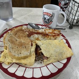 Meat lovers omelette with hash browns, Rye toast and delicious coffee!  A tasty and very satisfying breakfast!