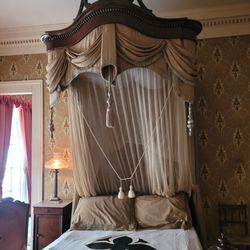 Gallier House - Period accurate bed clothes including mosquito net used to protect from the transmission of yellow fever.