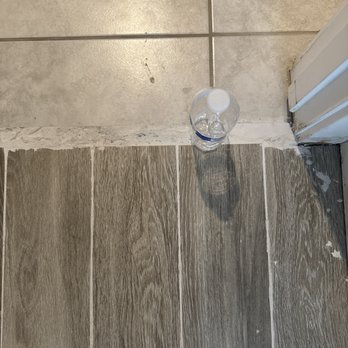 Drill It & Build It - Flooring grout too thick by the door. And a little uneven from existing tile. - Painters Near Me
