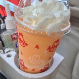 an orange drink with whipped cream