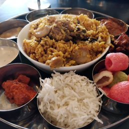 The chicken thali - thalapakatu chicken biryani takes the center stage with an assortment of sides!