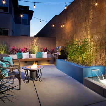 Promise Path Landscaping - Small modern look backyard with custom water feature and wood seating bench. - Irrigation Near Me - Chula Vista, California Promise Path Landscaping - Small modern look backyard with custom water feature and wood seating bench. - Irrigation Near Me - Chula Vista, California