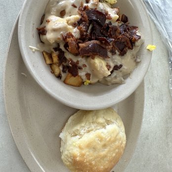 Tudor's Biscuit World - Little Tater combo (potatoes covered in gravy, scrambled eggs and bacon) with a  giant biscuit - Breakfast & Brunch Near Me - Beaver, West Virginia
