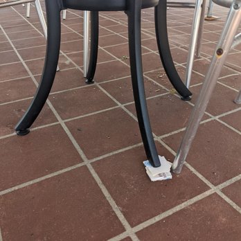 Gatsby on the Ocean - The table held up with cardboard and in the background the coleslaw from remnants of another diners meal under the seat my father sat in. - American Near Me - Wantagh, New York