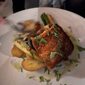 Birdsall House - Cajun Blackend Salmon with mix vegetables - A dish featuring Cajun blackened salmon served with mixed vegetables, garnished with chopped herbs, on a white plate. - Venues & Event Spaces Near Me - Peekskill, New York