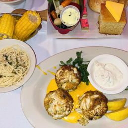 Crab cakes w. garlic pasta, yellow rice, and corn Crab cakes w. garlic pasta, yellow rice, and corn