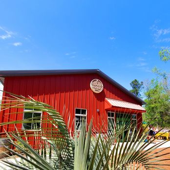 Island Winery - a red building with a palm tree in front of it - Wineries Near Me - Hilton Head Island, South Carolina Island Winery - a red building with a palm tree in front of it - Wineries Near Me - Hilton Head Island, South Carolina