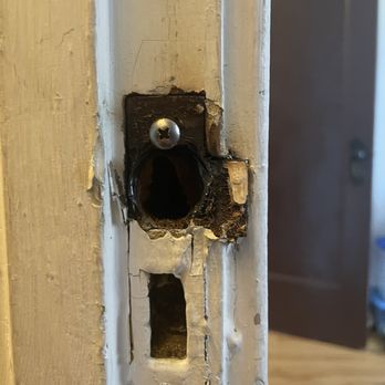 Chicago Locksmiths - Drilled catch rather than setting properly. Also crude steel round head screw instead of flathead brass screw - Security Systems Near Me - Chicago, Illinois