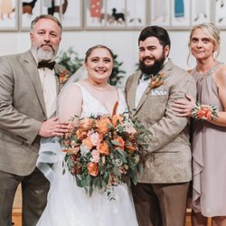Brush Valley Floral - Newlyweds and family celebrating with a colorful fall-inspired wedding bouquet designed by Brush Valley Floral.