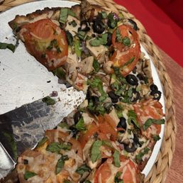 Cauliflower crust, dairy free cheese, veggie pizza, added grilled chicken and fresh basil. Veggie Delight