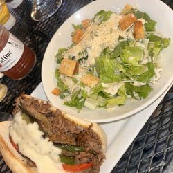 T.J. Hooligan’s - Philly cheese steak sandwich and Caesar side salad