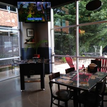 Society Pie - Inside dining. Golf on the tv and a foosball table. - Pizza Near Me - Hillsboro, Oregon