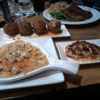 Ulele - Collection of appetizers that I created as a meal. Crab mac, lobster cake, and alligator hush puppies in the back. Waterworks Meatloaf (back - New American Near Me - Tampa, Florida