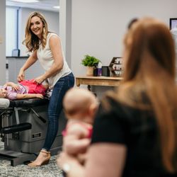Restoring Life Chiropractic - Dr. lauren adjusting some of our chiro kiddos