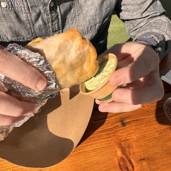 Papi’s Burritos - Dipping the burrito in guassacaca just - Breakfast & Brunch Near Me - Orlando, Florida