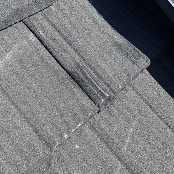 Garner Roofing - Attempts at hiding the damaged tile with black spray paint - Roofing Near Me - Rancho Cordova, California