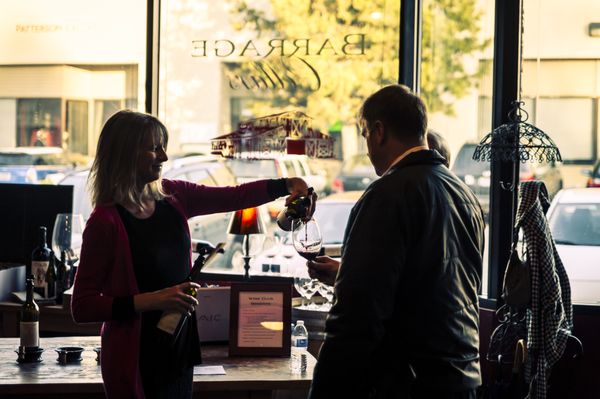 Photo of Barrage Cellars - Woodinville, WA, US. Bonni pouring a tasting for wine club members.