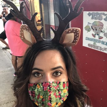 PJ’s Shaved Ice And Snacks - a woman with reindeer antlers on her head - Food Trucks Near Me