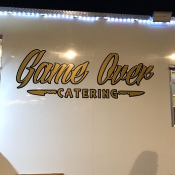 Game Over Catering - a man standing in front of a food truck - Caterers Near Me - Ventura, California