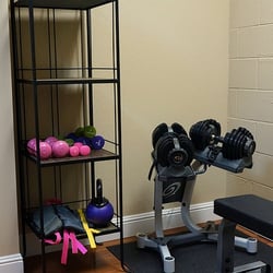 Trimm-Way Weight Loss & Nutrition Center - Weights and weight bench in Trimm-Way's fitness area.