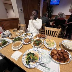 Hunan Garden - Owusu from Ghana enjoying his first Chinese Christmas dinner