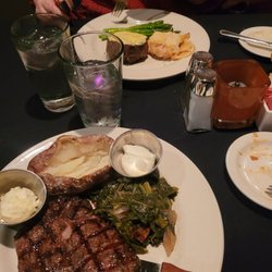 The Blackstone Grille - Delmonico with Baked Potato and Collard Greens (Front). Filet with Scalloped Potates and Asparagus (Back).