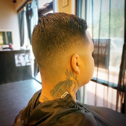Low to mid bald fade with low back dip/ drop.