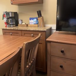 Table shoved up against the kitchen storage cabinet