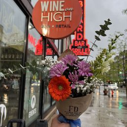 a person holding a bunch of flowers a person holding a bunch of flowers