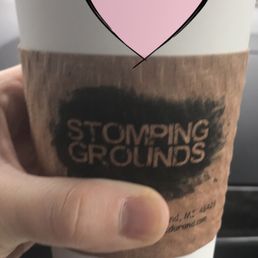 a hand holding a cup of coffee
