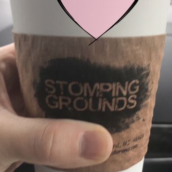 Stomping Grounds - a hand holding a cup of coffee - Coffee & Tea Near Me - Durand, Michigan