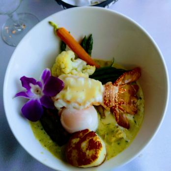 Chefusion - Lobster tail, pork, veggies, gnocchi and an edible orchid. - Lounges Near Me - Green Bay, Wisconsin