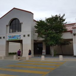 two people walking in front of a building