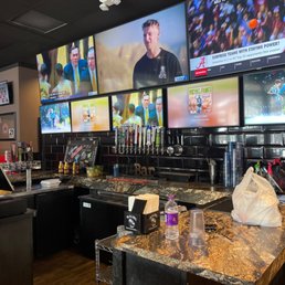 a bar with multiple televisions a bar with multiple televisions