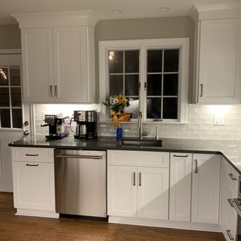 About Kitchens and Baths - a kitchen with white cabinets and stainless steel appliances - General Contractors Near Me - Annapolis, Maryland