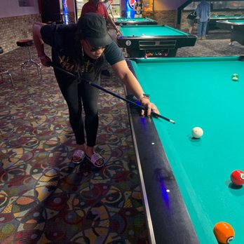 Pockets Billiards - a man playing pool - Pool Halls Near Me - Crestwood, Illinois