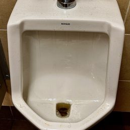 7:30am disgusting urinal with weeks of dirt, pubic hair and urine on the floor. 7:30am disgusting urinal with weeks of dirt, pubic hair and urine on the floor.