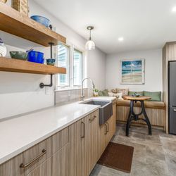 KRB Kitchen and Bath Design Center - An industrial inspired kitchen featuring rich wood tones and plenty of texture.