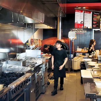 Via Cibo - a man and a woman working in a restaurant kitchen - Italian Near Me - Toronto, Ontario