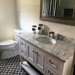 Covenant Contractors - Recent bathroom renovation with tile flooring and tile shower/tub combo.