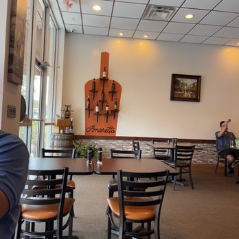 Amaretto Ristorante - a man sitting at a table in a restaurant - Italian Near Me - Tampa, Florida Amaretto Ristorante - a man sitting at a table in a restaurant - Italian Near Me - Tampa, Florida